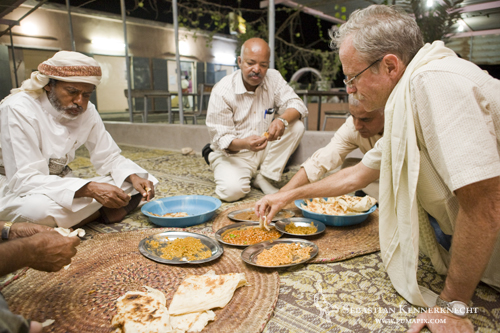 David Stanton (right) and Yousuf Mohageb (center) eating dinner, Yemen