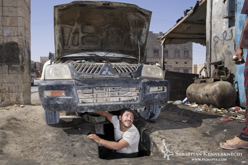 Mechanic under car, Yemen