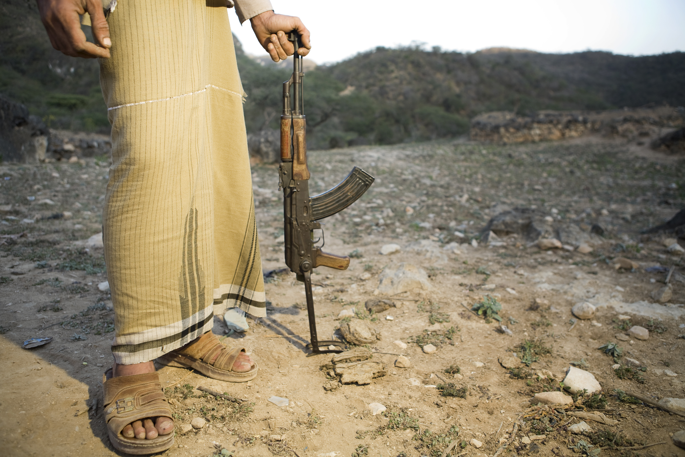 Yemeni man holding Kalashnikov used to hunt wildlife, Hawf Protected Area, Yemen